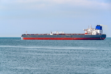 Crude oil tanker in navigation off the coast of The Netherlands on a partly cloudy summer day