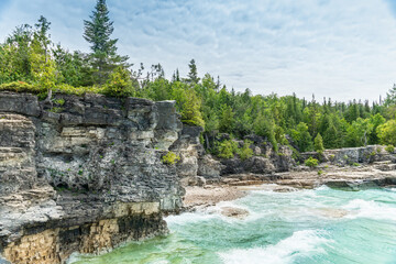 Colourful green waters at Indian Head Cove on lake Huron in Bruce Peninsula National Park and clear blue water in Ontario, Canada. Located between The Grotto and Overhanging rock tourist attractions.