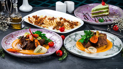 Top view of modern cuisine set including Pasta Carbonara pasta with bacon on table in restaurant