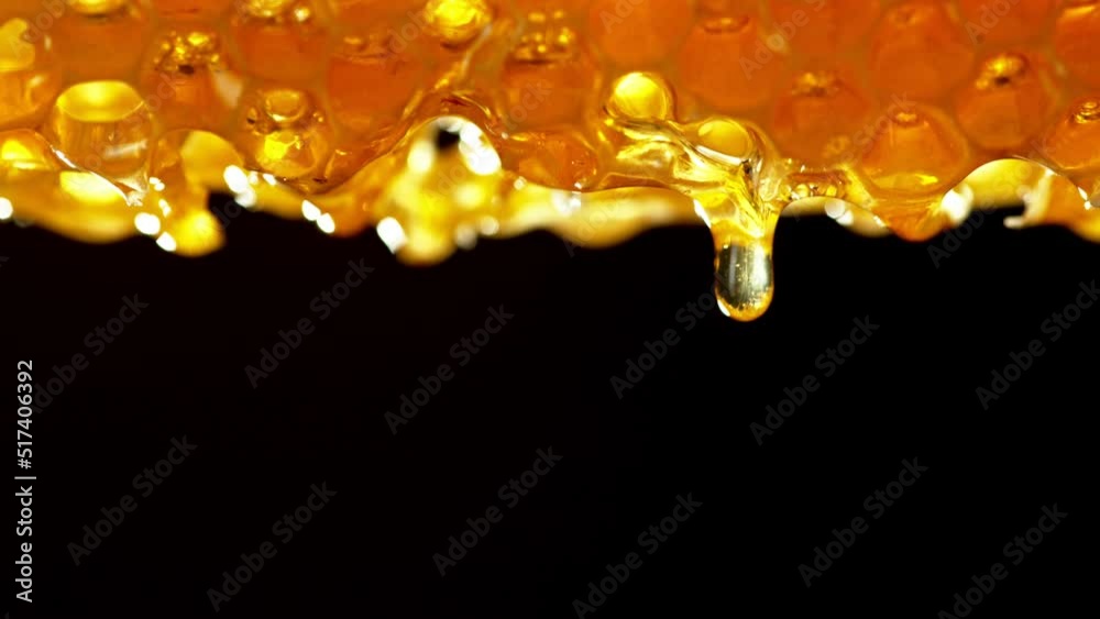Aufkleber super slow motion of dripping honey from honeycomb on black background. camera in motion. filmed on 