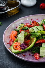 Ketogenic diet breakfast. Salt salmon salad with tomatoes, arugula and avocado. Keto, paleo lunch.