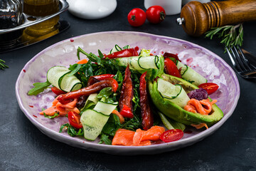 Ketogenic diet breakfast. Salt salmon salad with tomatoes, arugula and avocado. Keto, paleo lunch.