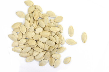 Heap of pumpkin seeds isolated on white background
