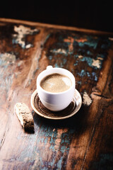 Cup of coffee and Cantuccini (Italian cookie) on dark wooden background. Copy space.	