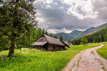 Gravely footpath near wooden cottages in Tatras Mountains, Poland
