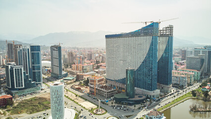 Obraz premium Aerial view of the modern architecture of Batumi with mountains background