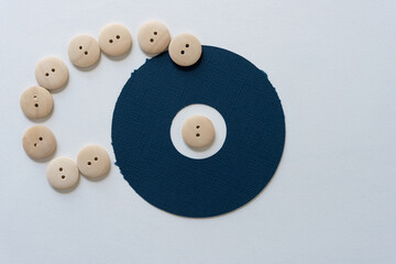 blue paper ring and wood buttons on blank paper