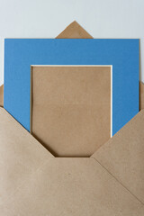 brown envelope and blue picture mat board