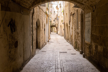 Fototapeta premium Old paved street in the small town of Sommière in the Gard, South of France