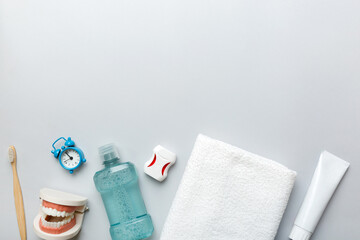 Mouthwash and other oral hygiene products on colored table top view with copy space. Flat lay. Dental hygiene. Oral care products and space for text on light background. concept