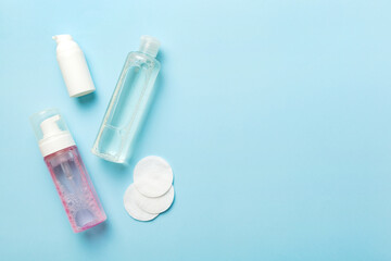 Micellar cleansing water and discs to remove cosmetics and cleanse the skin on colored background. Copy space top view