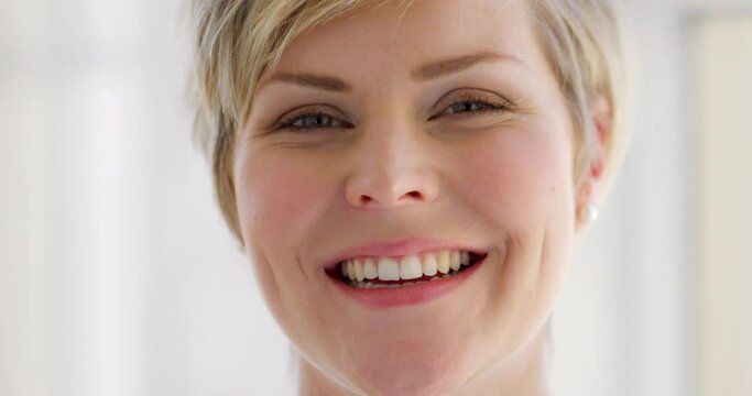 Portrait of a cheerful, happy and confident woman with a positive attitude smiling and laughing with joy. Face of a beautiful caucasian female with beautiful smile feeling excited and in a good mood