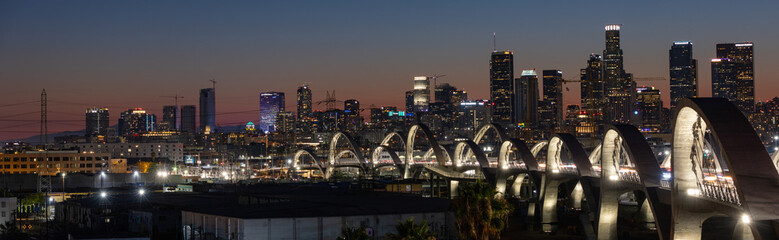 New 6th Street bridge in Los Angeles at sunset with the Los Angles skyline in the distance - obrazy, fototapety, plakaty