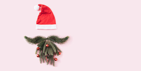 Christmas decoration with Santa Claus hat, fir-tree mustache and beard and New Year decorations on...