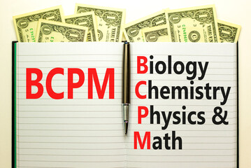 BCPM biology chemistry physics math symbol. Concept words BCPM biology chemistry physics math on white note on beautiful dollar background. Business BCPM biology chemistry physics math concept.