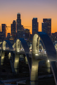 New 6th Street bridge in Los Angeles at sunset with the Los Angles skyline in the distance
