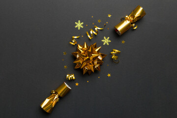 Christmas crackers with shiny confetti on color background, top view, copy space