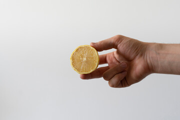 holding fresh raw juicy lemon, healthy vitamin diet