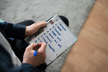 writing a shopping list on the paper, buying reminder