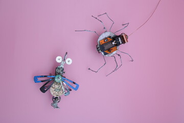 a robot spider attacks a robot fly