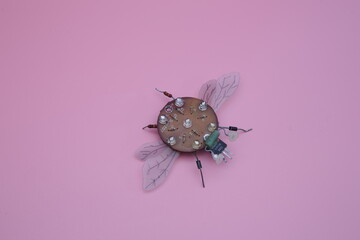 a robot fly made from scrap metal