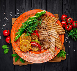 Vegetables and meat cooked on an electric grill