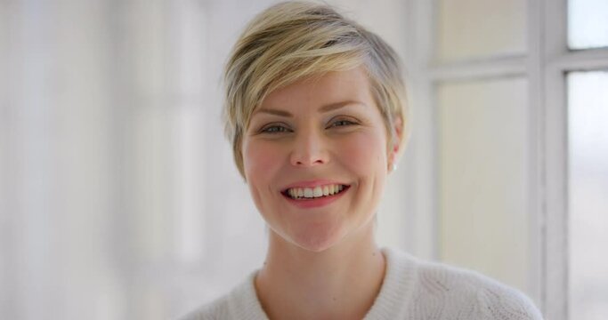 Portrait of a happy young woman with bright and beautiful smile. Confident and cheerful caucasian female laughing with joy while feeling excited, optimistic and in a good mood with positive attitude