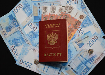 the passport of a citizen of Russia lies on the background of Russian rubles of various denominations. resilience of the economy and financial system to sanctions and restrictions