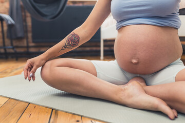 Fototapeta na wymiar pregnant woman doing relaxing exercises, motherhood concept. High quality photo