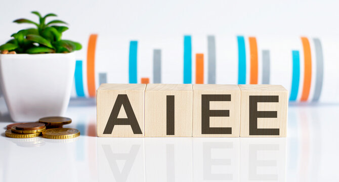 AIEE - American Institute of Electrical Engineers word letters on wooden blocks with coins.