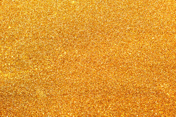 Shiny gold sparkles glitter background for new year, Christmas, wedding design of invitations and postcards with copy space