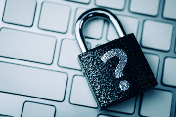 Question mark concept or FAQ. The sign on the padlock on the keyboard, as a symbol of security