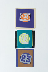 the number 23 (three times) on paper pieces