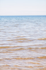 Copy space at the sea with a clear blue sky background above the horizon. Calm ocean waters at an empty beach. Peaceful and scenic coastal landscape for a relaxing and zen summer getaway in nature