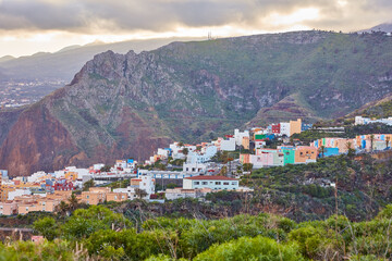 Fototapeta premium Historical spanish or colonial architecture in tropical village in tourism destination. City and mountain view of residential houses or buildings in serene hill valley in Santa Cruz, La Palma, Spain.