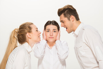 team of young business people in white shirts on a white background isolated. a team of two girls and a guy is happy, wins, plans, argues, discusses, gets upset, wins something. close-up portrait 
