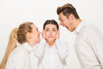 Fototapeta premium team of young business people in white shirts on a white background isolated. a team of two girls and a guy is happy, wins, plans, argues, discusses, gets upset, wins something. close-up portrait 