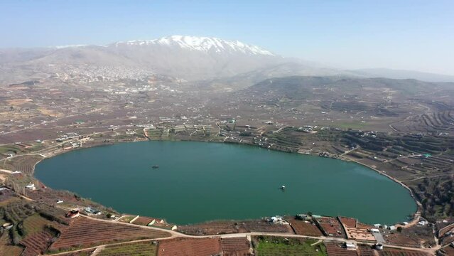 Ram Lake and snowy mount Hermon in Northern Israel, Drone footage.
