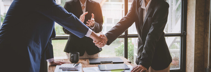 Business team shaking hands and clapping after a business deal Image of business partners...