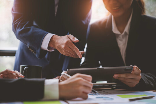 Business meeting team. Photo young account managers crew working with new startup project. Notebook on wood table. Idea presentation, analyze plans.