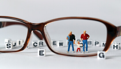 Business concept with glasses and miniature people. Concept about 'love is love'. 
