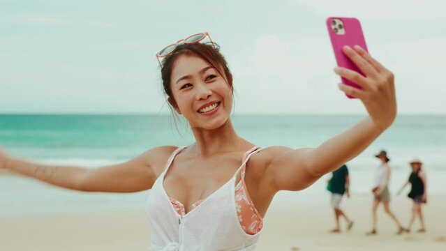 Asian woman uses a smartphone to video call or facetime with family