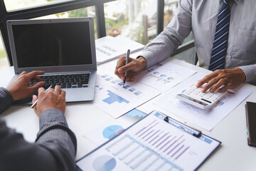 Teamwork, analyze, Business meeting.business team brainstorming discussing with paper graph chart in the office while sitting at the office table together