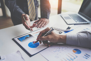 Teamwork, analyze, Business meeting.business team brainstorming discussing with paper graph chart in the office while sitting at the office table together
