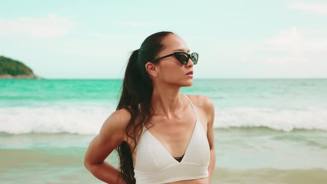 Portrait of a sport fashion Asian woman tan skin in black bikini 
