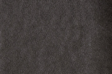 Dark gray background from natural slate. Texture of stone closeup. Graphite background macro