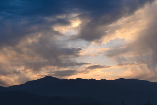 Scenery of clouds and mountain valley after rainfall during sunset
