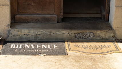 Close-up on the threshold of a home and its welcome mats