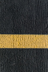 black concrete and yellow line for wallpaper or background
