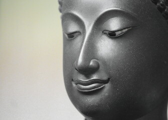 The head of an ancient Buddha statue was made of bronze. image on copy space white background.